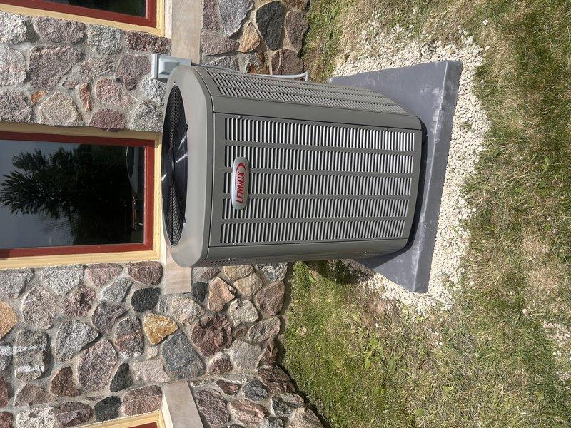 Completed full HVAC system installation including new air conditioning unit and evaporator coil. Replaced 35-foot line set and ran new 4-wire electrical connection to Cutler Hammer panel with 50-amp breaker. Lowered existing furnace to accommodate new "D" width evaporator coil, ensuring proper clearance below existing ductwork on right side. Modified return air configuration on bottom box to allow air intake from both bottom and side positions. Coordinated PVC condensate routing to maximize space clearance for planned wall construction adjacent to furnace. Installed outdoor condenser unit on concrete pad with proper electrical connections and refrigerant charging. System tested and operational upon completion.