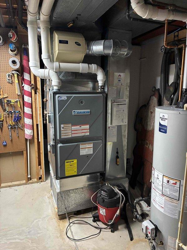 Completed annual prepaid maintenance visit on Daikin furnace system with customer not present, accessing property via provided garage code. Performed comprehensive system inspection including visual assessment of furnace, ventilation components, and associated mechanical equipment in basement utility area. Replaced heavily soiled 20x25x5 air filter which showed significant dust and debris accumulation, contrasting with the clean condition of the heat exchanger coils. Documented equipment condition through photographic records showing proper operation of HVAC system, water heater, and ventilation piping. All components found operating within normal parameters upon completion of maintenance protocol under CCC Quality Plan coverage.