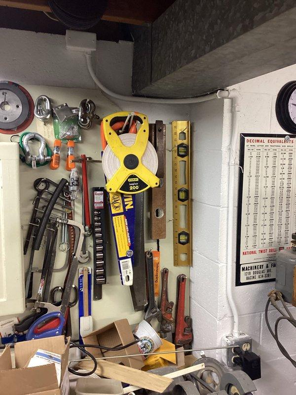 Conducted site assessment for electrical service upgrade involving pedestal replacement and new pedestal installation. Documented existing meter configuration mounted on exterior wall with conduit routing through vegetation. Reviewed tool inventory and equipment requirements necessary for completing the service upgrade work.