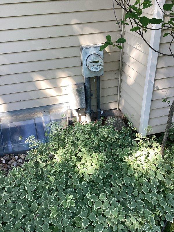 Conducted site assessment for electrical service upgrade involving pedestal replacement and new pedestal installation. Documented existing meter configuration mounted on exterior wall with conduit routing through vegetation. Reviewed tool inventory and equipment requirements necessary for completing the service upgrade work.