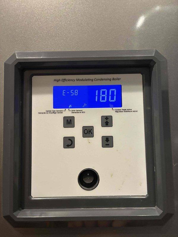 Responded to no hot water complaint at carriage house reporting only lukewarm water delivery. Upon arrival, inspected high efficiency modulating condensing boiler and found control panel displaying error code E-58 with temperature reading of 180°F. Diagnosed fault code indicating system issue preventing proper hot water production. Evaluated plumbing distribution system including manifold assemblies, zone valves, and piping configuration serving the carriage house. Cleared error code, reset boiler parameters, and verified proper system operation. Tested hot water delivery to carriage house and confirmed restoration of adequate hot water temperature throughout. System returned to normal operation with all components functioning as designed.