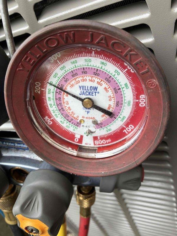 Completed installation of new air conditioning unit and evaporator coil in a congested mechanical space with limited clearance, utilizing a "D" width coil measuring 26.25" tall to accommodate existing ductwork configuration. Reused existing line set buried in ceiling, verified proper refrigerant pressures using manifold gauges, and integrated new equipment with existing 12-year-old furnace and zoned system while working around non-standard filter setup. Confirmed electrical connections at Cutler Hammer panel with 15-amp furnace circuit and 50-amp AC circuit, removed old AC unit, and ensured all components operational before completion.