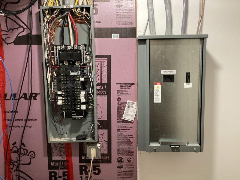 Installed Kohler model 20RCA 20kW air-cooled standby generator with aluminum cabinet on compacted stone base with 3-inch concrete pad on side of residence. Mounted 200A service-rated automatic transfer switch adjacent to main electrical panel with proper grounding and bonding per code requirements. Ran all necessary line voltage and low voltage wiring from generator to transfer switch and main panel. Installed natural gas piping and fittings from existing gas line to generator, painting exterior gas line gray with oil-based paint. Generator equipped with battery, carburetor heater, and oil heater for cold weather operation. Configured Kohler OnCue monitoring system for remote generator status and diagnostics. Verified proper operation of automatic transfer switch during simulated power outage, confirming seamless transition between utility and generator power. All work completed to manufacturer specifications and local electrical code requirements.