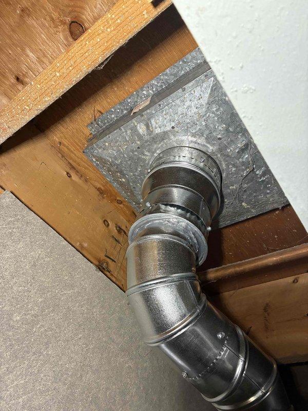 Installed new 4" chimney liner system for water heater venting, including B-vent cap, 3" to 4" reducer, and necessary pipe sections with elbow fittings. Properly secured all ductwork connections through ceiling joists using galvanized metal flange and ensured proper ventilation pathway from water heater to exterior termination point.