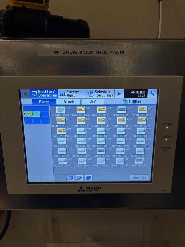 Responded to no heat call at multi-unit residential facility with Mitsubishi VRF system displaying error code 5112 on AE-200 control panel affecting multiple rooms. Diagnosed faulty TH12 thermistor sensor in branch controller unit causing intermittent heating operation where units would initially blow warm air then shut down. Replaced defective temperature sensor, cleared error codes from system, and verified proper heating operation across all affected zones including rooms 8a, 8b, 9, 10, 11, 12, 14, 15, and 16 with PKFY-P12NHMU-E2 indoor units. System restored to full heating functionality.