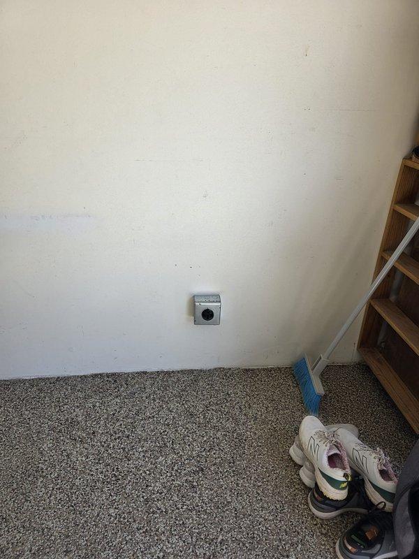 Installed a NEMA 14-50 outlet in the front corner of the garage for electric vehicle charging. Ran approximately 25 feet of electrical conduit and wiring through the open basement area to the new outlet location. Removed the existing EV breaker from the main electrical panel and replaced it with a Cutler-Hammer 250-amp breaker to properly support the new circuit requirements.