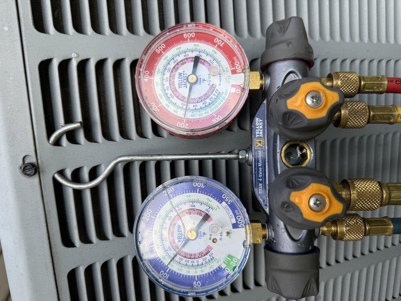 Responded to air conditioning unit freezing issue over multiple service visits. System was found to be low on R-410A refrigerant, causing evaporator coil to freeze. Used manifold gauge set to diagnose refrigerant pressures and confirmed undercharge condition. Added R-410A refrigerant to bring system to proper operating levels. Observed dirty evaporator coil with visible contamination and dust accumulation, which may have contributed to restricted airflow and freezing condition. System restored to operational status following refrigerant charge correction.