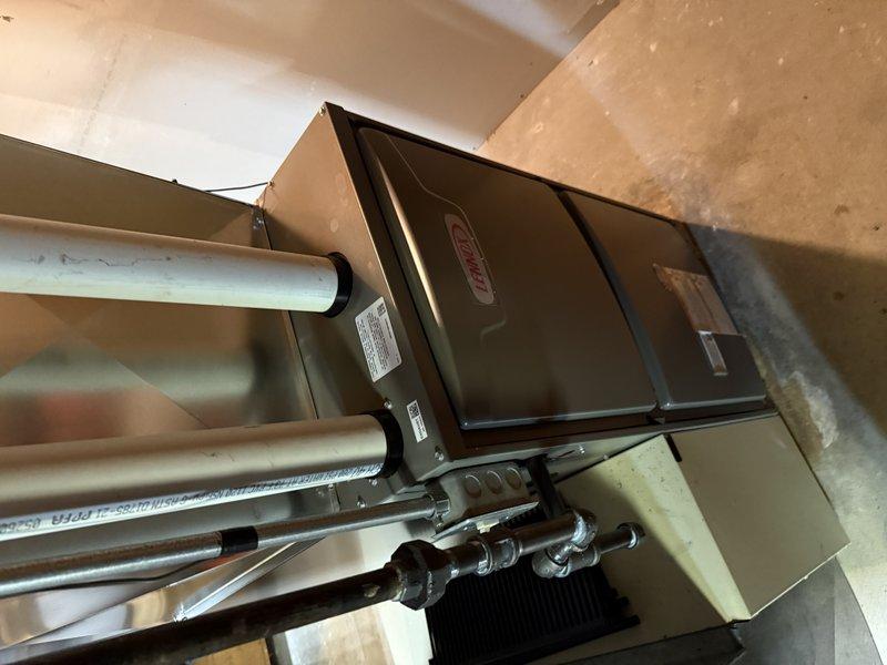 Completed installation of ML196XE 70,000 BTU high-efficiency furnace in basement utility area. Unit was properly positioned, leveled, and secured with all gas lines, PVC venting, and condensate drainage connected per manufacturer specifications and local code requirements. System was tested and verified operational upon completion.
