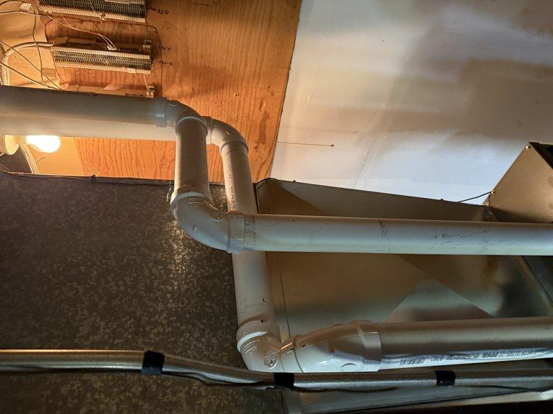 Completed installation of ML196XE 70,000 BTU high-efficiency furnace in basement utility area. Unit was properly positioned, leveled, and secured with all gas lines, PVC venting, and condensate drainage connected per manufacturer specifications and local code requirements. System was tested and verified operational upon completion.