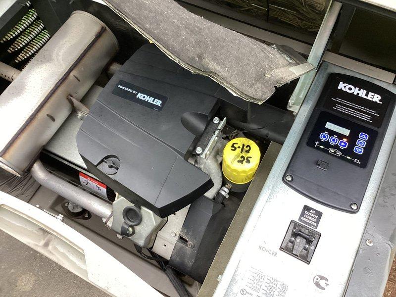 Responded to service call for non-operational Kohler generator with failed controller. Diagnosed control panel malfunction and replaced defective controller unit with new OEM component. Verified proper operation with system displaying correct voltage (240V) and frequency (60.0Hz) readings, confirmed all indicator lights functioning, and tested AUTO/RUN modes for proper generator startup and operation.