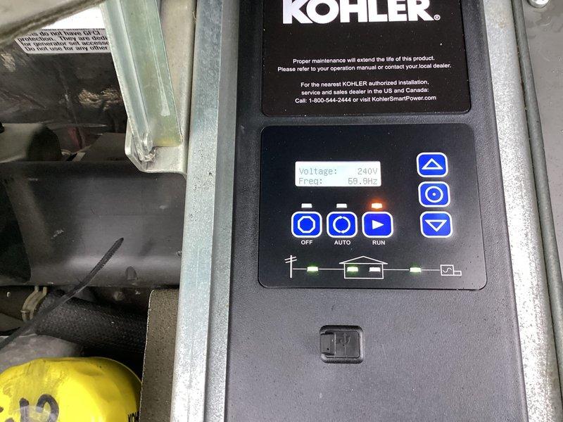 Responded to service call for non-operational Kohler generator with failed controller. Diagnosed control panel malfunction and replaced defective controller unit with new OEM component. Verified proper operation with system displaying correct voltage (240V) and frequency (60.0Hz) readings, confirmed all indicator lights functioning, and tested AUTO/RUN modes for proper generator startup and operation.