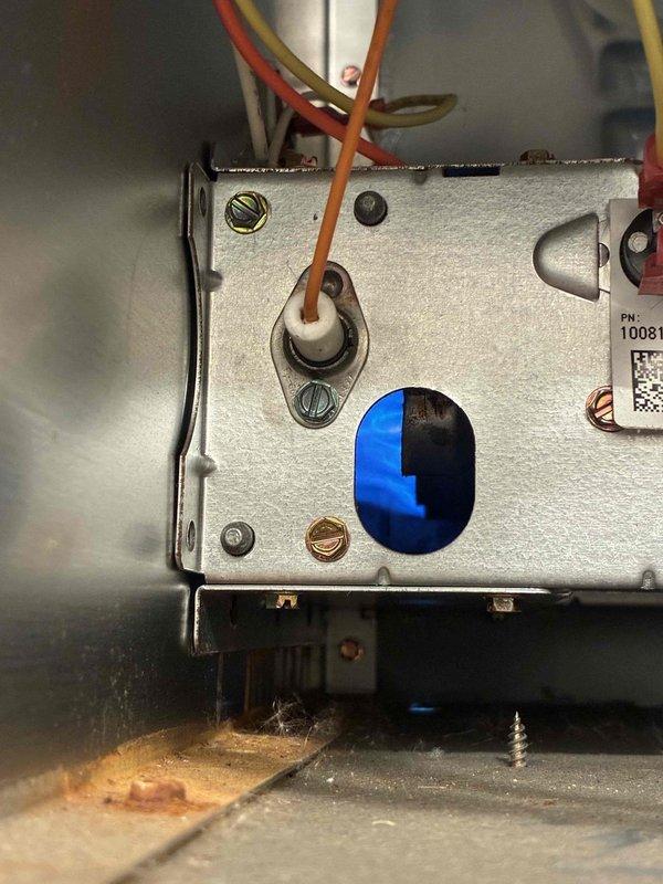 Responded to no heat call on aging HVAC system. Upon inspection, accessed main cabinet and evaluated blower motor assembly, electrical connections, and control board components. Documented system configuration showing multiple warning labels and organized wire bundles throughout compartment. Examined control component with part number 10081, noting proper terminal connections and wire routing from unit. All electrical connections were secure with no loose terminals observed. System components appeared functional with proper mounting and organized wiring harnesses maintained throughout cabinet. Blower motor assembly and ductwork connections were intact with no visible damage to mechanical components.