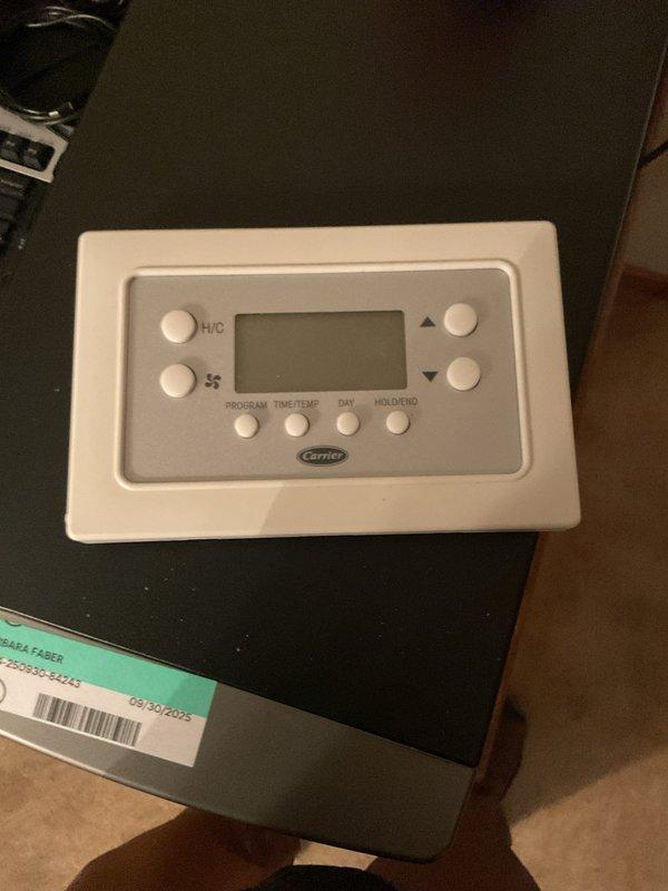 Responded to upstairs thermostat malfunction while downstairs unit operated normally. Upon inspection, identified faulty battery contacts preventing proper thermostat operation. Replaced existing Carrier programmable thermostat with new unit to restore system functionality and ensure reliable temperature control.