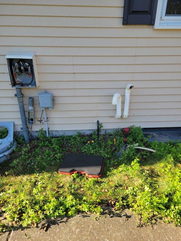 Installed Kohler model 26RCA 26kW air-cooled standby generator with aluminum cabinet on compacted gravel with concrete base at side of residence. Mounted 200A service-rated automatic transfer switch adjacent to electrical meter socket and relocated existing PVC exhaust piping to accommodate installation. Separated grounds and neutrals in existing main electrical panel, provided proper grounding and bonding per code requirements. Installed battery, carburetor heater, and oil heater with generator unit. Ran necessary low-voltage and line-voltage wiring from generator to transfer switch and main panel. Installed natural gas piping and fittings from existing gas line to generator, painting exterior gas line gray with oil-based paint. Verified all electrical connections, tested automatic transfer switch operation, and confirmed proper generator startup and load transfer functionality.