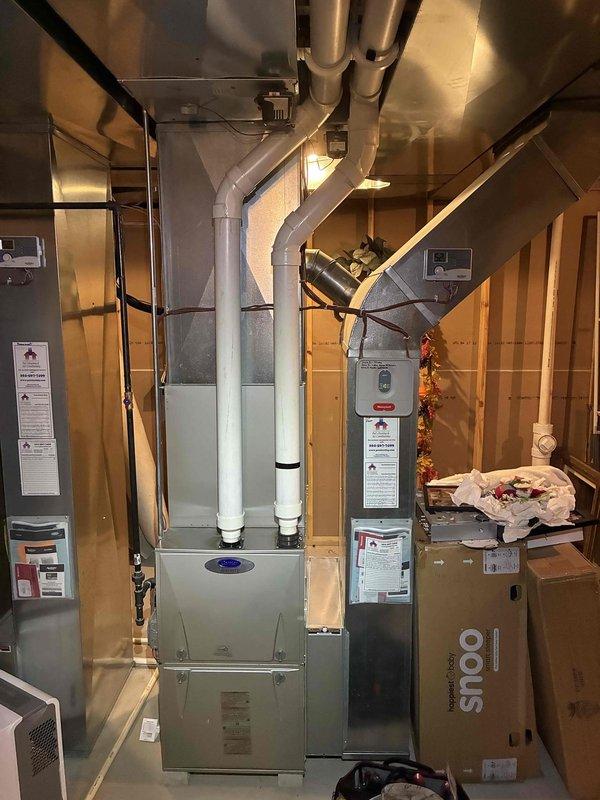 Responded to a call for whistling in the ductwork, a recurring complaint, and inspected the gas furnace, air handler, plenum, and supply/return duct connections for airflow restrictions. Visual inspection showed the furnace, flex duct transitions, and condensate drain lines in place, with dust on the plenum but no frost, ice, or rust on the air handler. System was left in operation and the customer was advised to monitor for noise recurrence.