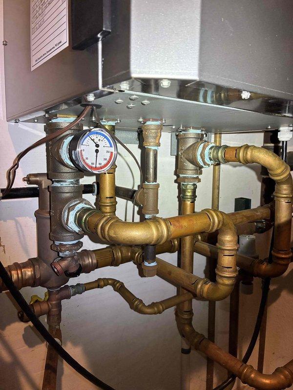 Replaced the internal valve on the boiler and verified proper operation of the associated piping and fittings. Inspected the system, noting an oxidized threaded connection on an upper fitting and a recorded expansion tank pre-charge of 14 psi. Repair was performed under parts warranty only, and a recommendation was documented for future boiler evaluation or replacement should additional issues arise.