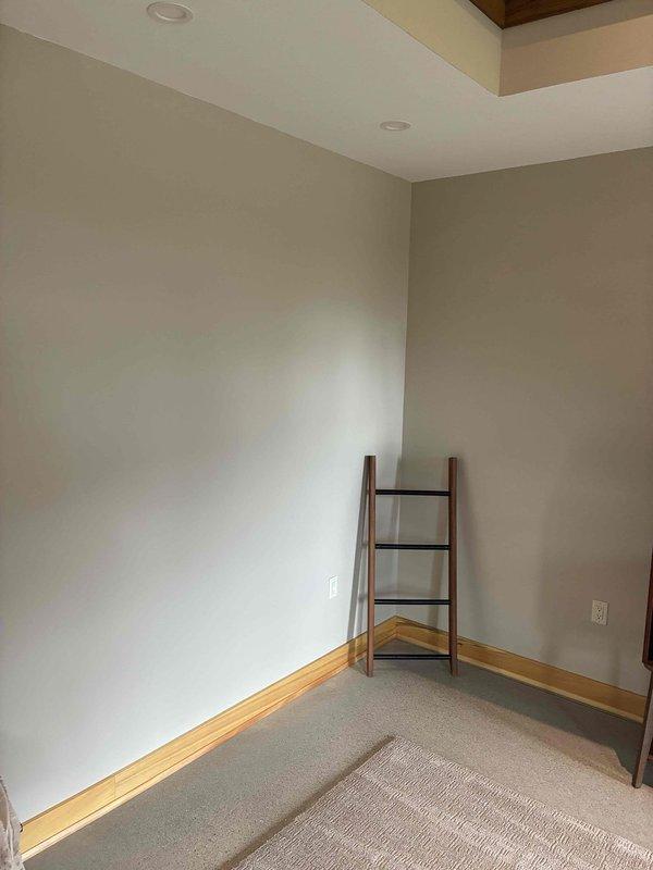 Responded to a customer complaint of uneven heating and cooling in the main residence and inspected the zoned ductwork, including the plenum, round trunk takeoffs, mastic-sealed ceiling penetrations, and damper actuator wiring. Observed the damper actuator and low-voltage control wiring to be secured and intact, with no visible air leakage, damage, or anomalies at the duct connections or conditioned space.