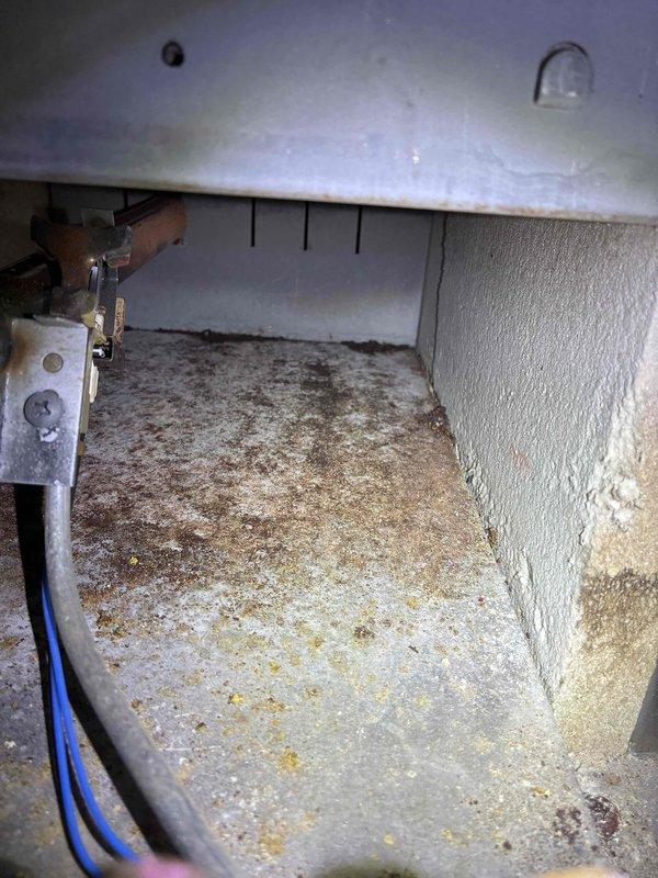 Performed annual prepaid maintenance on the boiler, inspecting the burner compartment and combustion area, including burner tubes, igniter/sensor assembly, and flame pattern, which showed normal operation upon startup. Noted significant corrosion, rust buildup, and debris on the combustion chamber floor and surrounding surfaces, along with a crack in the refractory material, and recommended further evaluation and repair to prevent further deterioration.