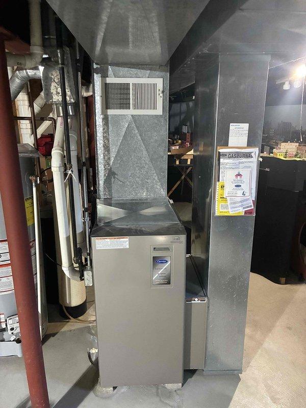Responded to a no-heat call on a 20-year-old Carrier upright gas furnace and performed a full diagnostic of the unit, including inspection of the cabinet, supply plenum, ductwork, condensate drain assembly, and PVC venting. No visible frost, rust, or equipment damage was observed at the furnace. Verified the unit's operating condition and documented the installation with photos.