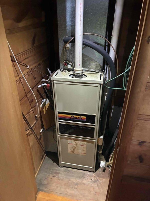 Responded to a no-heat call at a Plus 90 condensing gas furnace and inspected the unit, including the condensate drain, PVC venting, and associated piping, for the reported water leak inside the equipment closet. Found a heavily soiled return air filter restricting airflow and replaced it, and cleared and secured the condensate drain components to correct the leak and restore normal heating operation.