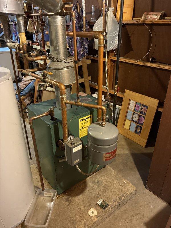 Responded to a boiler leak on startup and diagnosed the expansion tank and pressure relief valve as failed and the source of the leak. Inspected the boiler piping, flue, zone valves, and discharge line, with a drip tray in place to contain discharge. Documented system conditions with photos and prepared a repair quote for replacement of the expansion tank and relief valve.