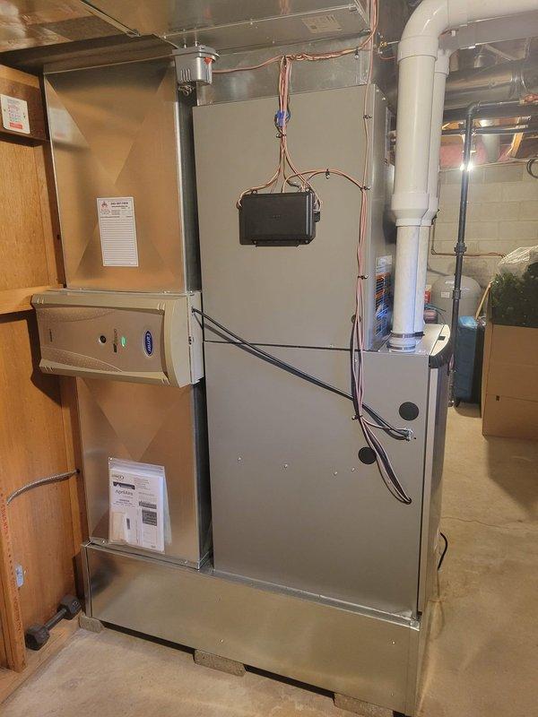 Installed a new furnace, air conditioner condenser, evaporator coil, and Aprilaire power humidifier, replacing the existing units. Modified the return drop and fabricated custom ductwork transitions to adapt the existing trunk lines to the new equipment, relocated two 6" round supply runs, and upsized the PVC condensate/venting from 2" to 3". Reused the existing Carrier air purifier, reconnected controls and wiring, and removed unused circuits, with dedicated circuits run for the new AC unit and furnace by an electrician.
