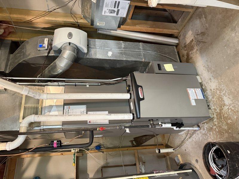 Installed a new gas furnace in the basement mechanical area, reusing the existing media filter cabinet, return drop, zoning controls, thermostats, and 2" solid core PVC, and connecting it to the existing side-mounted cased coil. Piped the PVC intake, exhaust, and condensate drain, then terminated and verified the low-voltage control wiring at the furnace control board. The electrical panel has a 20 amp breaker where a 15 amp is required, so an electrician is needed to swap it.