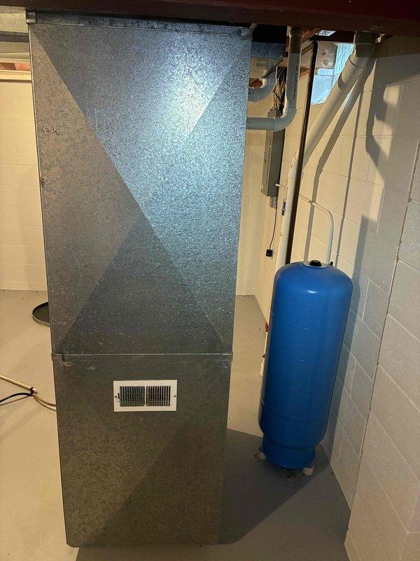 Performed a seasonal heating tune-up on an 11-year-old Goodman gas furnace, inspecting the cabinet, venting, and condensate and PVC flue connections and checking components related to the customer's reported intermittent ignition. Verified proper operation of the unit and surrounding ductwork, and found no visible rust, cracks, or damage; the system is ready for the heating season.