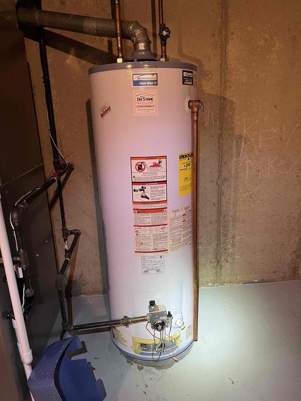 Performed standard BFMA tune-up service on 1-year-old furnace, confirming proper operation. Carbon monoxide testing showed safe levels (0.0 PPM) using General DCO1001 detector. Inspected water heater during service noting proper installation with intact pressure relief valve and no visible issues.