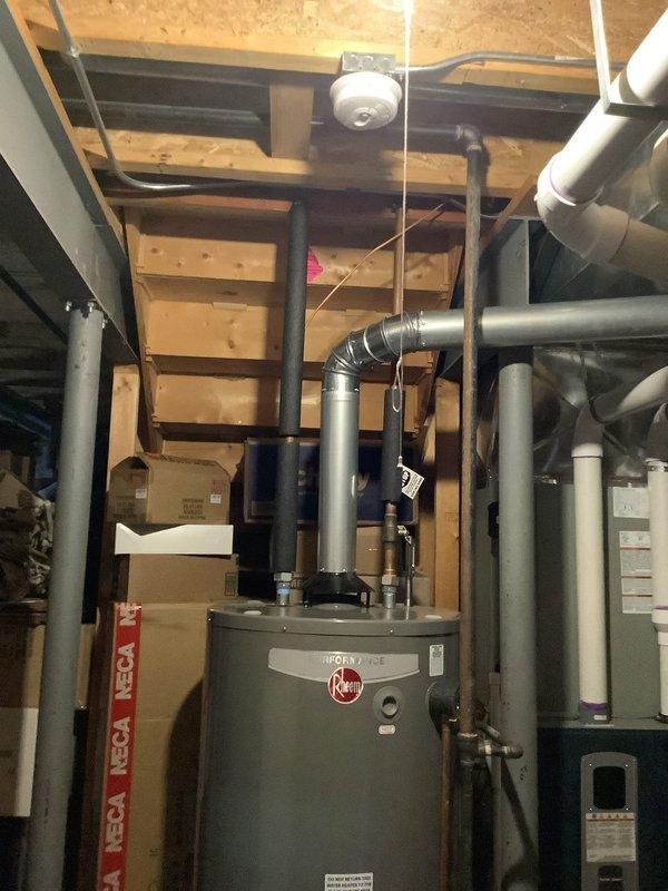Conducted comprehensive inspection of existing Rheem tank water heater system in unfinished basement for potential replacement with tankless unit. Evaluated current plumbing configuration, gas line sizing, venting requirements, and available wall space for mounting. Documented existing HVAC integration points and identified necessary modifications to accommodate tankless conversion, including potential upgrades to water and gas lines. Estimate provided to client who is comparing options with another vendor.