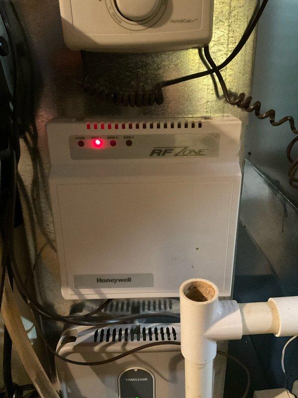 Successfully replaced faulty zoning panel and isolated thermostats with dedicated power source and relays as specified. Installed new Honeywell RF control unit and properly connected all components to resolve E1 error codes displayed on digital thermostats. All systems now functioning correctly with payment collected from tenant upon completion.