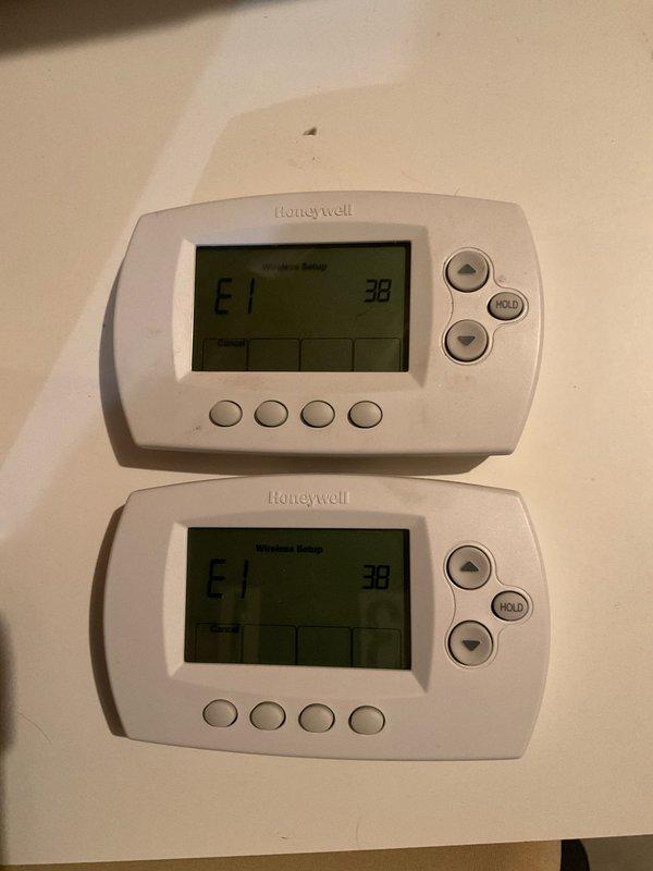 Successfully replaced faulty zoning panel and isolated thermostats with dedicated power source and relays as specified. Installed new Honeywell RF control unit and properly connected all components to resolve E1 error codes displayed on digital thermostats. All systems now functioning correctly with payment collected from tenant upon completion.