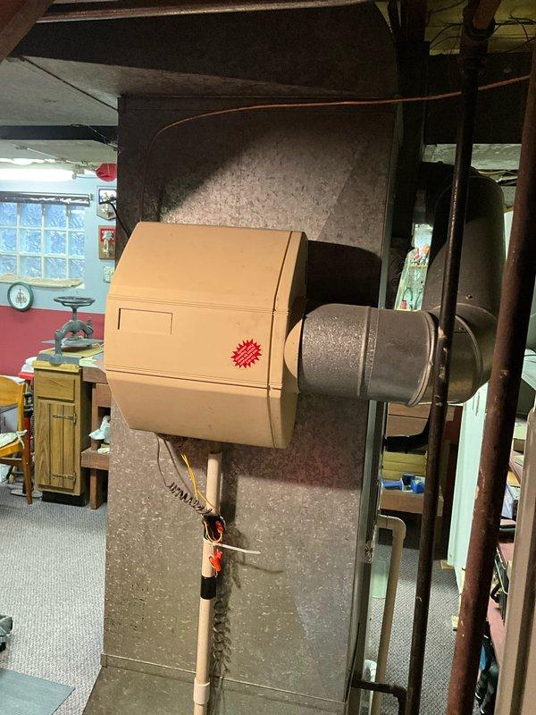 Performed diagnostic assessment on customer's humidifier system in response to reported malfunction and high water consumption. Inspected the beige humidifier unit mounted on the HVAC ductwork in the basement, examining connections and water supply lines. Determined the humidifier was leaking due to a faulty solenoid valve, which was replaced to restore proper operation and eliminate excess water usage.