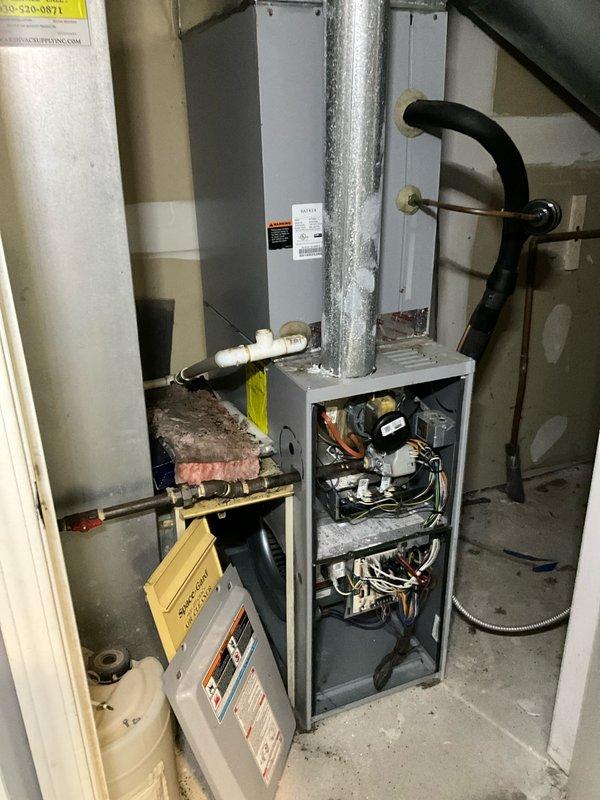 Responded to no-heat call for upstairs apartment furnace. Upon arrival, found thermostat functioning properly but displaying low indoor temperature (54°F) with 65°F set point. Inspection of furnace revealed faulty ignition module preventing system operation. Replaced ignition module, cleaned flame sensor, and verified proper ignition sequence. System now operating correctly and producing adequate heat.