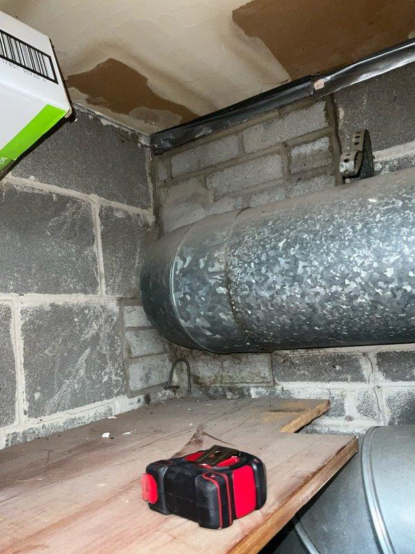 Performed chimney liner inspection as requested and completed cap off procedure. Observed water damage on ceiling near HVAC ductwork and documented condition of Rheem water heater system with associated piping and ventilation components in basement mechanical room.