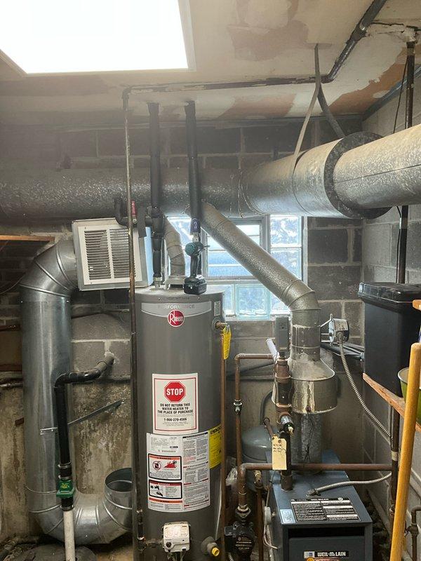 Performed chimney liner inspection as requested and completed cap off procedure. Observed water damage on ceiling near HVAC ductwork and documented condition of Rheem water heater system with associated piping and ventilation components in basement mechanical room.
