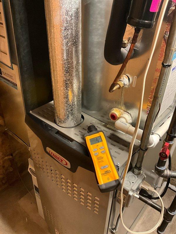 Responded to service call regarding sweet odor and foggy appearance in home. Performed diagnostic testing on Lennox furnace system with carbon monoxide detector showing safe "0" reading. Inspected crawlspace and PVC exhaust venting system, confirming proper installation and function with no gas leaks detected.