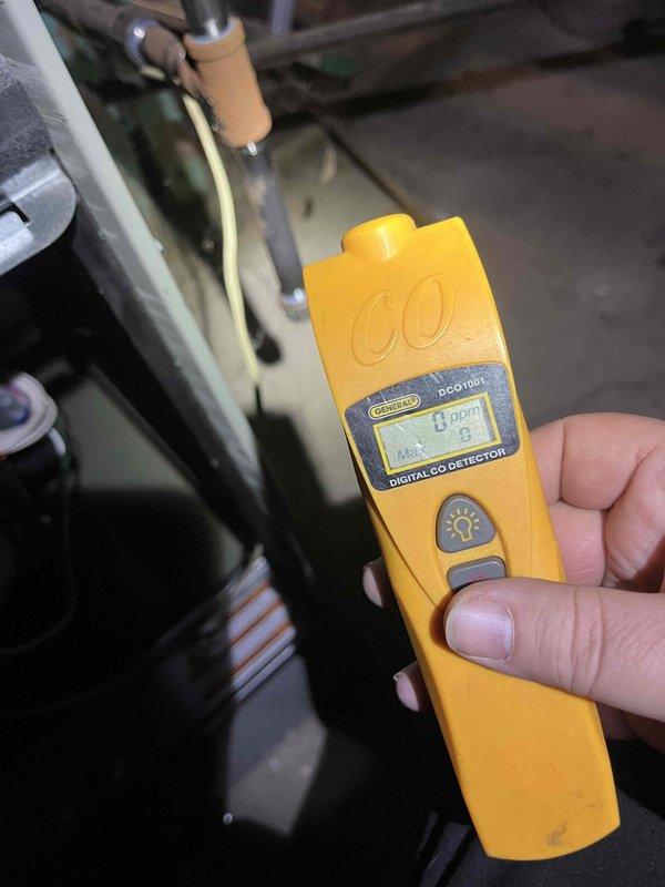 Performed scheduled maintenance service on residential HVAC system. Inspected and evaluated air filter condition, noting the pleated filtration material appeared relatively clean. Conducted carbon monoxide safety test using General DCO1001 detector, confirming readings of 0 ppm with no CO presence detected in the system.
