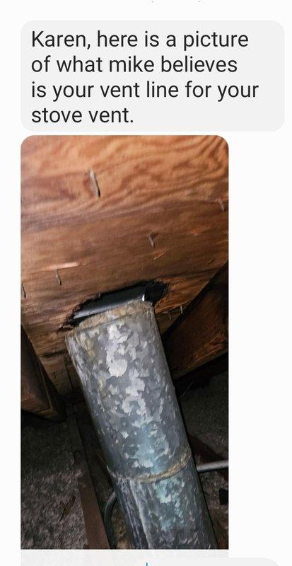 Accessed attic space via ceiling hatch to inspect kitchen exhaust vent line. Confirmed proper installation and connection of galvanized metal vent pipe running through wooden structural members. Verified ventilation pathway is clear and functioning as intended.