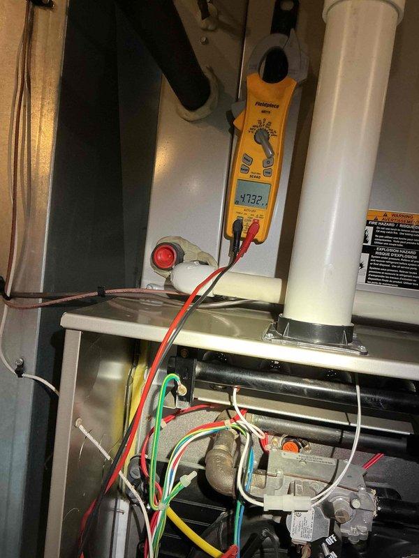 Performed comprehensive BFMA tune-up on customer's furnace system, including electrical component inspection and voltage testing with readings at 4.92V on the gas valve assembly. Inspected and verified proper operation of all safety controls, checked condition of PVC venting system, and examined filter placement for optimal airflow in the mechanical room setup.