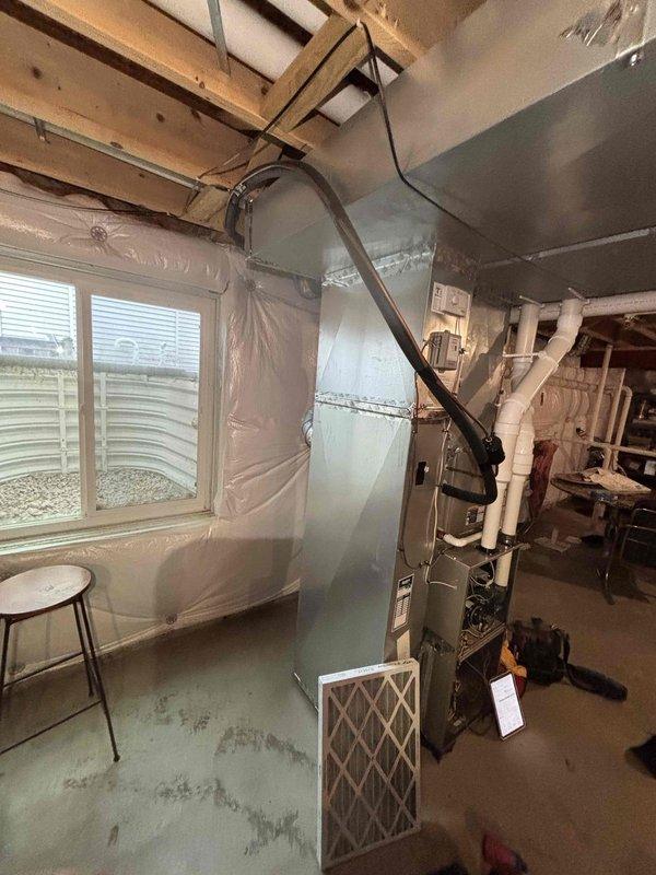 Performed comprehensive BFMA tune-up on customer's furnace system, including electrical component inspection and voltage testing with readings at 4.92V on the gas valve assembly. Inspected and verified proper operation of all safety controls, checked condition of PVC venting system, and examined filter placement for optimal airflow in the mechanical room setup.