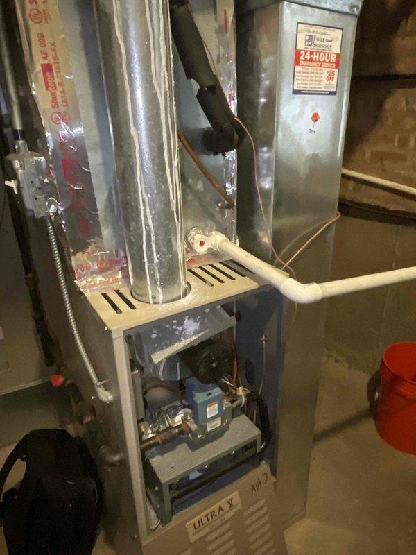 Performed inspection of basement furnace (Ultra V model) in Apartment 2. Accessed internal components to evaluate blower motor assembly, electrical connections, and heat exchanger. Unit appears to be in normal operating condition with typical dust accumulation but no signs of damage or malfunction to primary systems or connected ductwork.