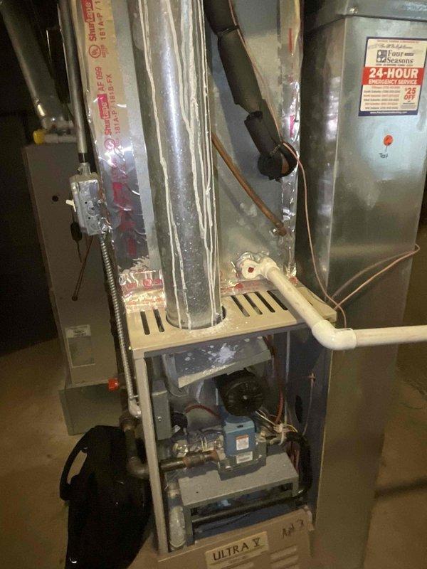 Performed inspection of basement furnace (Ultra V model) in Apartment 2. Accessed internal components to evaluate blower motor assembly, electrical connections, and heat exchanger. Unit appears to be in normal operating condition with typical dust accumulation but no signs of damage or malfunction to primary systems or connected ductwork.