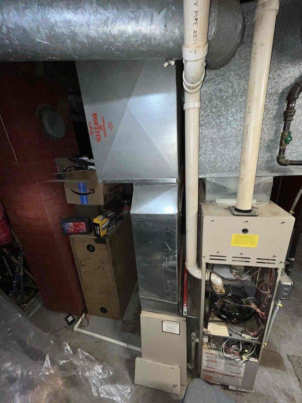 Conducted comprehensive assessment of aging furnace system in basement utility area. Found existing unit operational but with significant reliability concerns. Inspection revealed potential issues with ventilation system, including PVC pipe configuration and metal ductwork connections. Recommended replacement options to improve reliability and efficiency based on current installation constraints.
