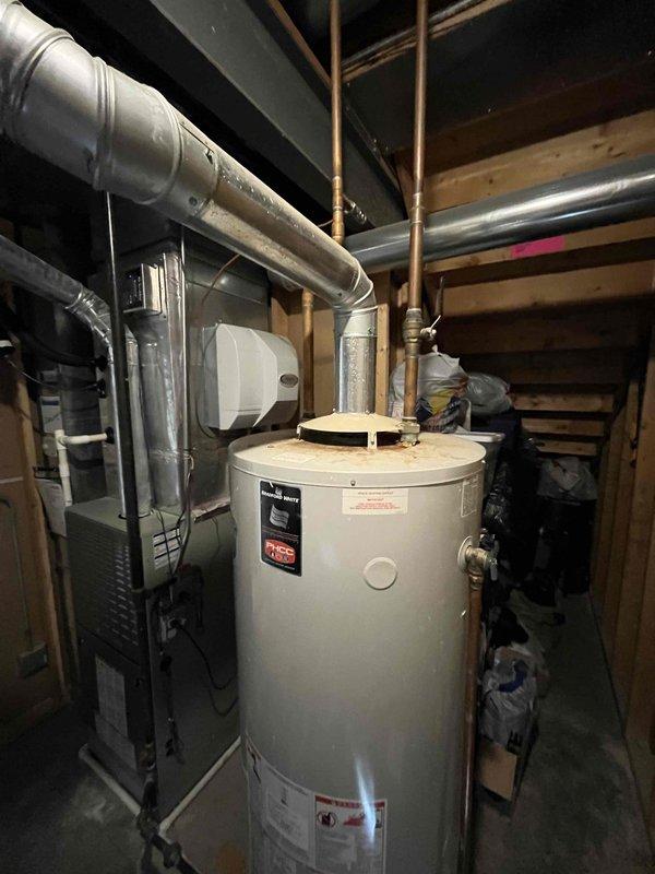Responded to "No Hot Water" service call at residential property. Inspected aging tanked water heater in unfinished basement with copper supply lines and visible signs of deterioration. Diagnosed and resolved issue, restoring hot water functionality to the home.
