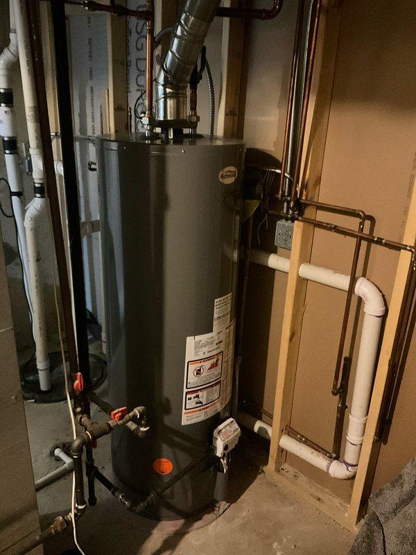 Completed BFMA tune-up on 11-year-old furnace system, which included inspection of the furnace unit with PVC exhaust/intake pipes and connected ductwork. System appears to be in good working condition with no visible damage. Also inspected the hot water heater installation with its associated plumbing components, vent pipe, and valves.