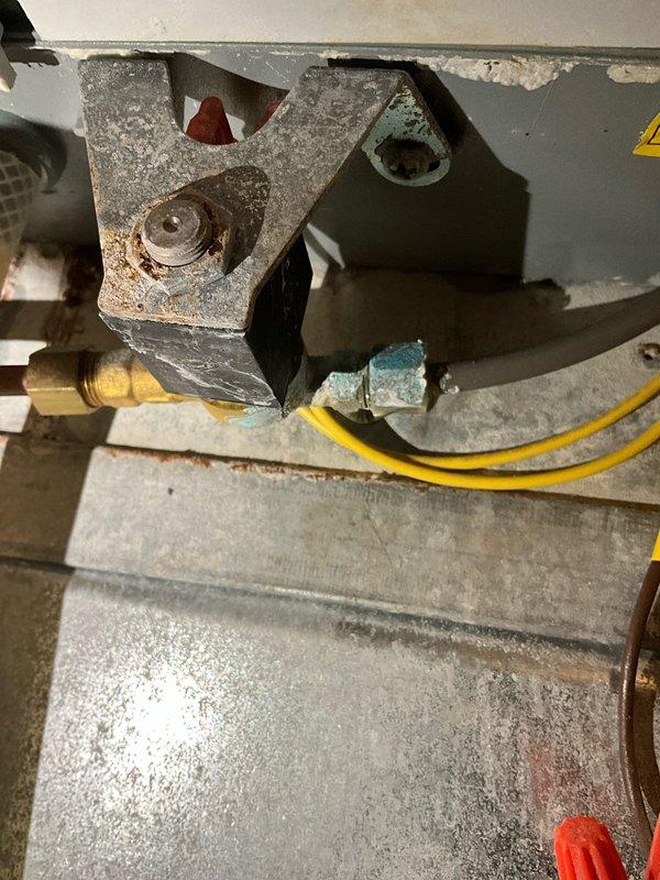Performed IAQ inspection and identified a leaking humidifier system with visible moisture accumulation at mounting bracket and valve assembly. Documented corrosion on metal components and water damage to surrounding materials. Repaired leak and recommended preventative maintenance schedule to avoid future moisture-related issues.