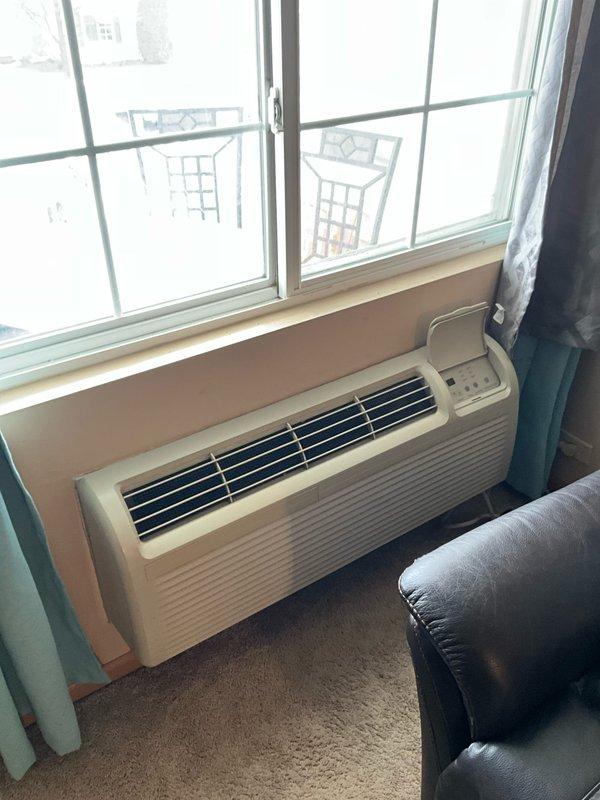 Diagnosed PTAC wall unit with no heat operation. Upon inspection, found dust accumulation on heat exchanger coils behind protective mesh screen. Cleaned heat exchanger and verified proper heating function before completing service.