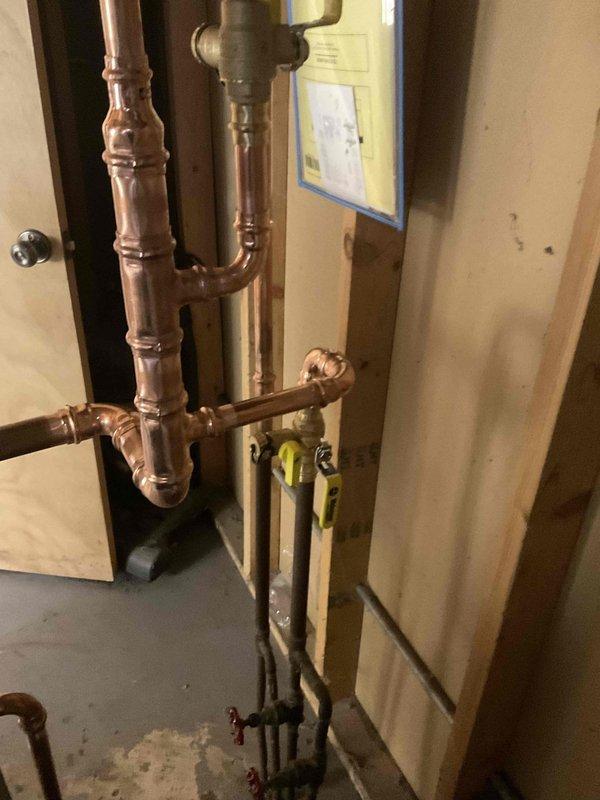 Successfully installed a Weil McLain CGA-4 boiler system with expansion tank in residential basement. Completed all necessary copper pipe connections with 1" and 3/4" fittings, and properly pressurized the system. System functionality verified with all components operating as designed.