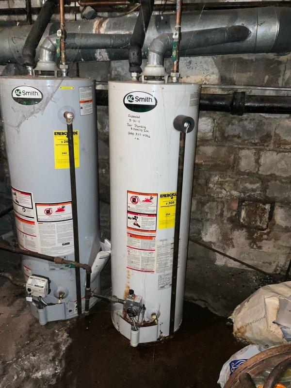 Successfully replaced the main control circuit board in Crown boiler that was previously staged at headquarters. Documented the installation with photos showing the A.O. Smith water heaters and Lennox heating system in the utility area. System is now operational with all connections properly secured.